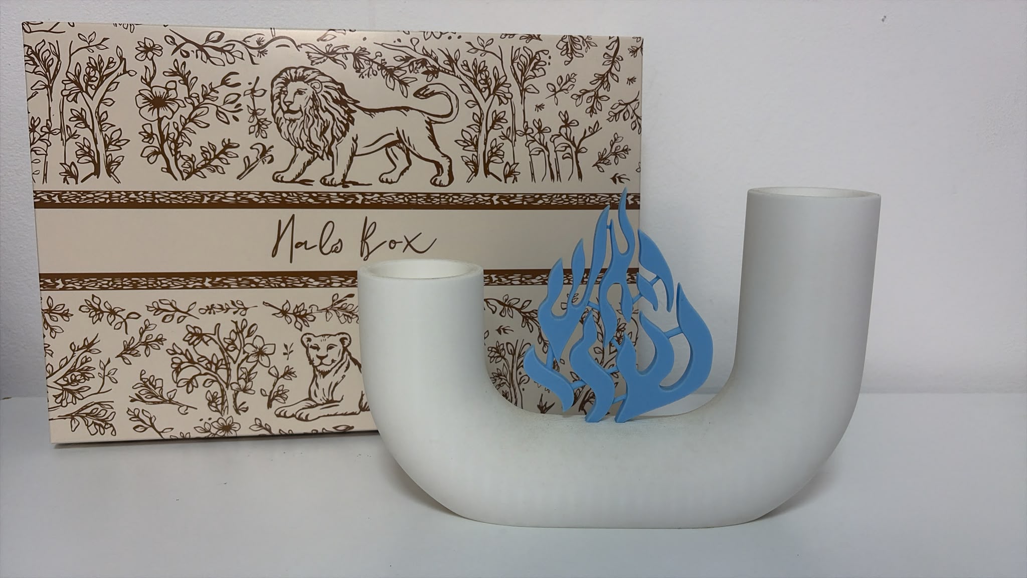 Bougeoir Arche blanc avec la flamme Na Nach, devant son coffret cadeau Halo-box
